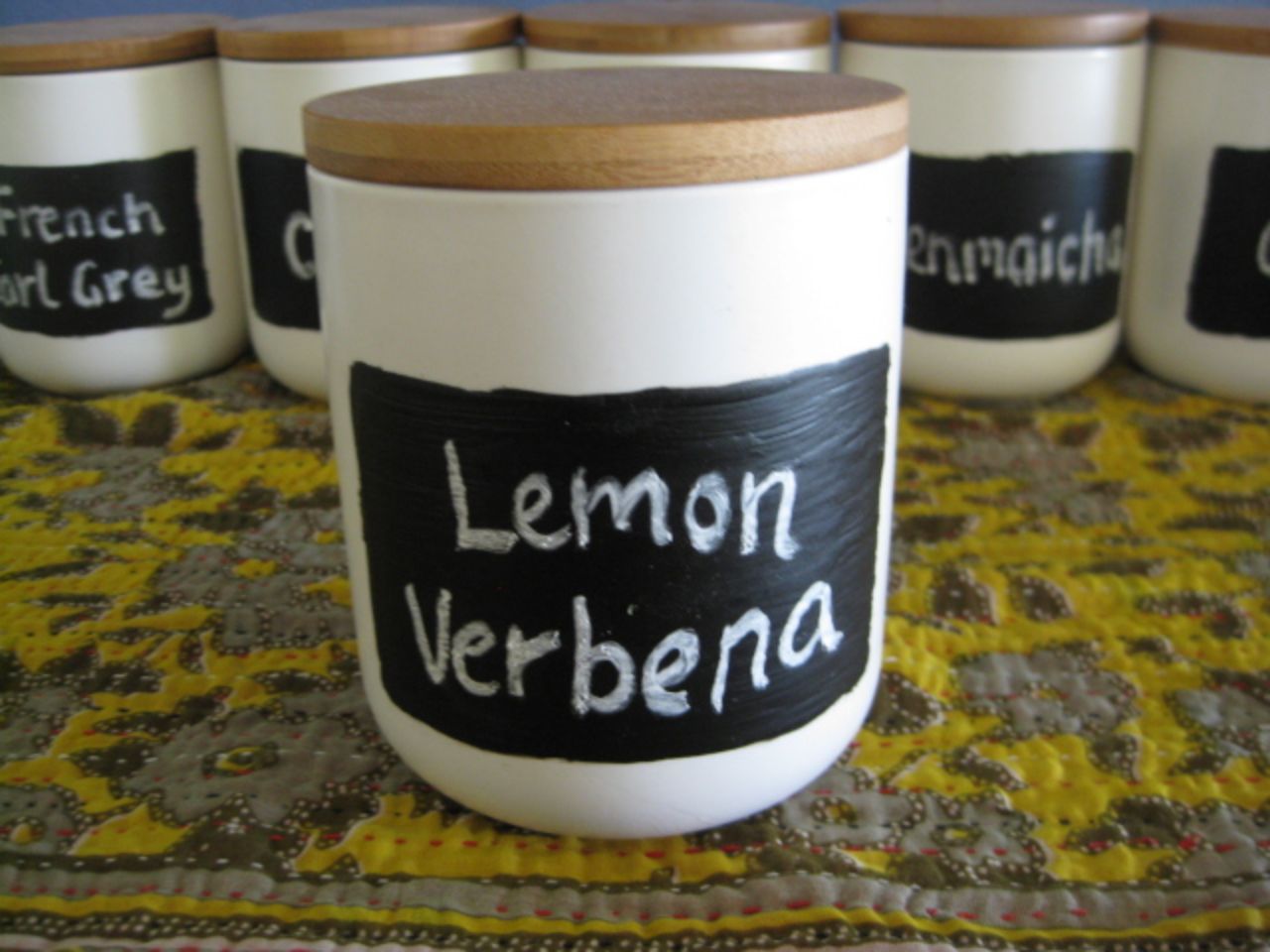 candle canisters repurposed for tea storage, painted with blackboard paint for tea labels