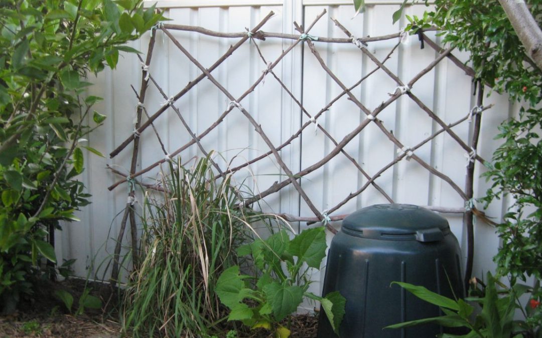 garden trellis made from locally gathered sticks and cut up pieces of old t-shirts